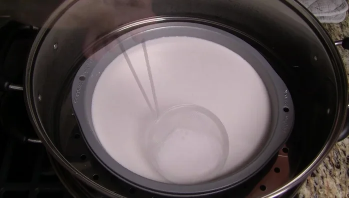 Wrap a towel around the steamer lid to maintain heat. Steam for 25-30 minutes, or until a toothpick inserted comes out with a few moist crumbs.