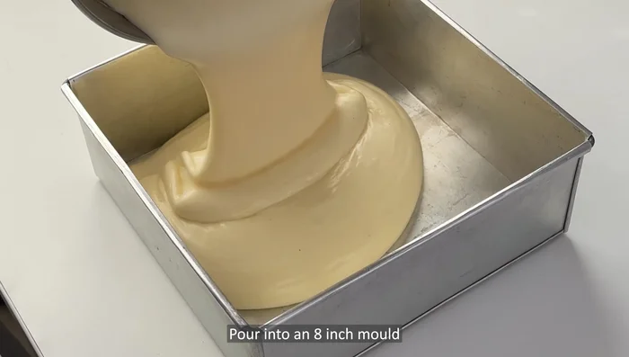 Pour batter into an 8-inch cake mold. Tap the mold on the table a few times to remove air bubbles.