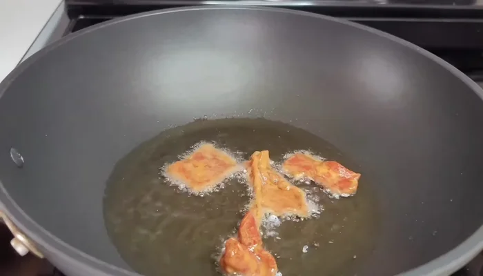 Heat cooking oil in a wok. Add the marinated beef in batches, browning it for about 2-3 minutes per batch. Remove and set aside.