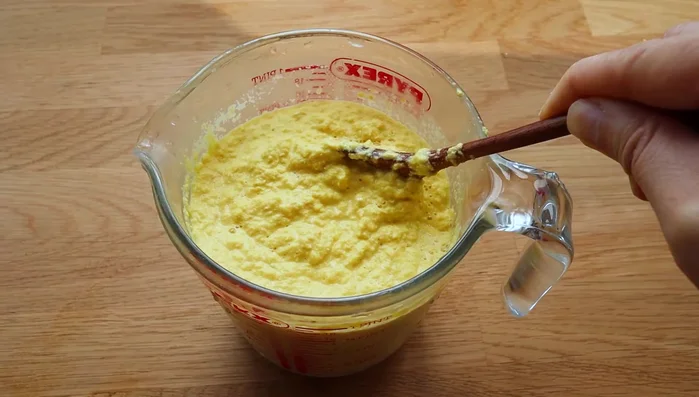 Transfer the corn mash to a container with a spout for easy pouring.