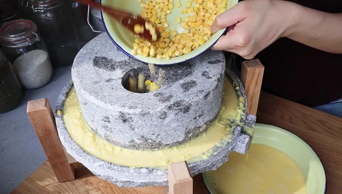 Grind 3 ears of corn using a stone grinder until you have approximately 2 cups of corn mash. Minimal water should be added.