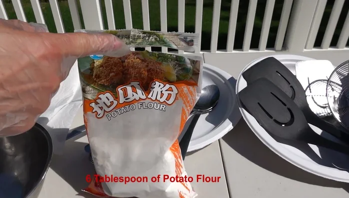 Mix together sweet potato flour, cornstarch, cooking wine, soy sauce, sugar, pink water, black pepper, ginger juice, and five spice powder.