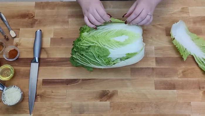 Remove the top leaves of the Napa cabbage, rinse it, and cut off any loose, thin leaves (you can save these for a salad).