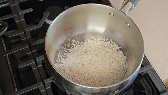 Cook rice: Combine 2 cups of rice and 3 cups of water, bring to a boil, then reduce heat to low, cover, and simmer for 20 minutes.
