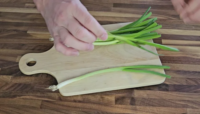 Prepare vegetables: Chop scallions, mince garlic, grate ginger, and chop red bell pepper.