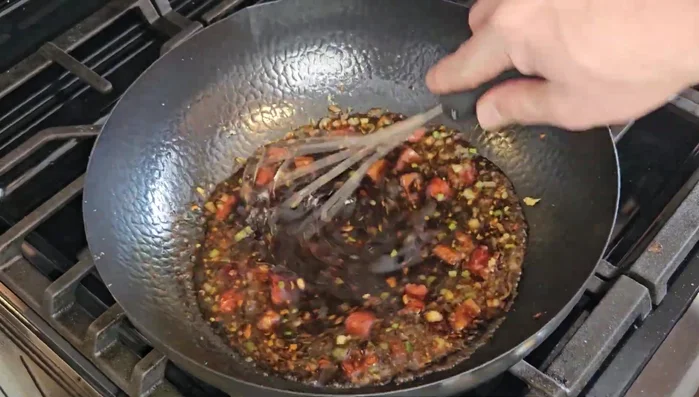Add the sauce mixture to the wok, reduce heat to medium-low, and simmer for 5 minutes, stirring occasionally. Thicken with a cornstarch slurry (3 tsp cornstarch mixed with 3 tsp water).