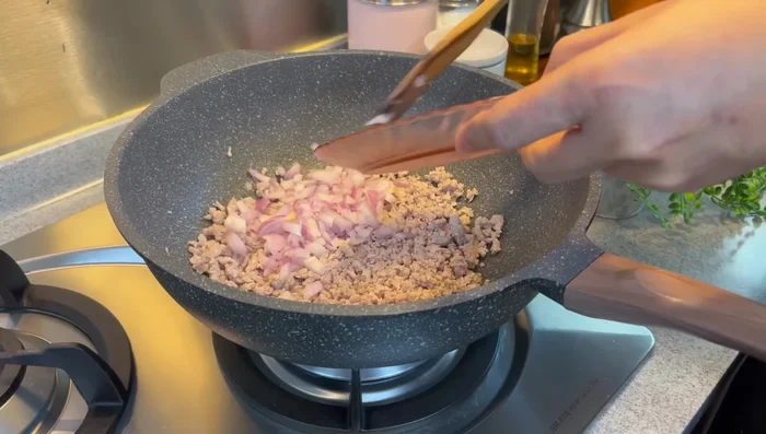 Add chopped onion and garlic. Mix well and fry until fragrant.