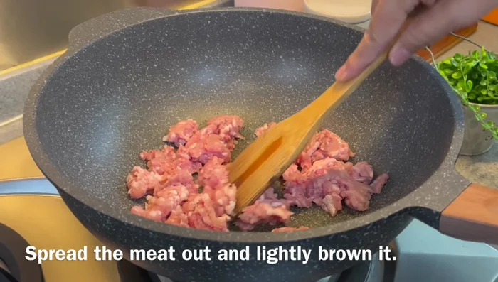 Add minced pork (or chicken), salt, and pepper. Fry until lightly browned, releasing the oil for more flavor.