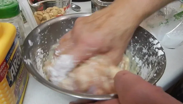 Add oil to the marinated chicken and mix.