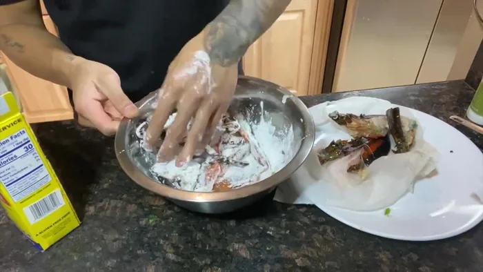 Fry the lobster halves in hot oil for one minute per side.
