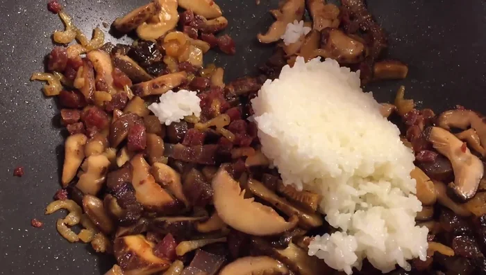 Add the cooked rice to the pan and mix everything together.