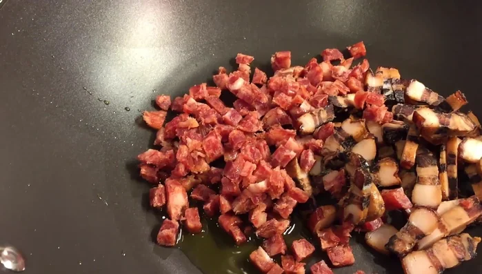 Once the rice is cooked, combine the meat with cooking oil in a pan. Stir and cook for about 10 minutes.