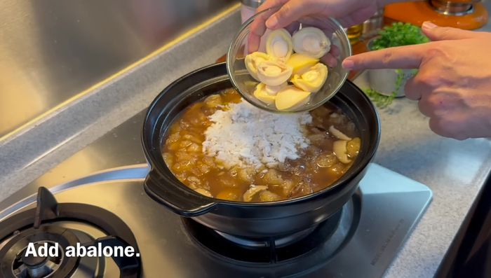Add crab meat and abalone. Stir gently. Turn off heat.