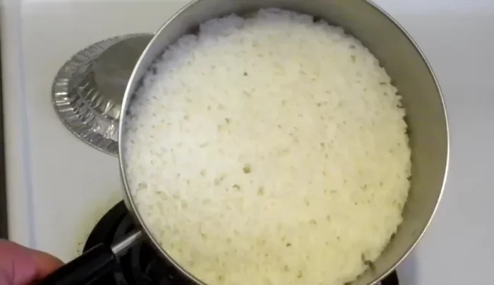 Once most of the water is absorbed (you'll see the rice at the bottom), give the rice a good stir.