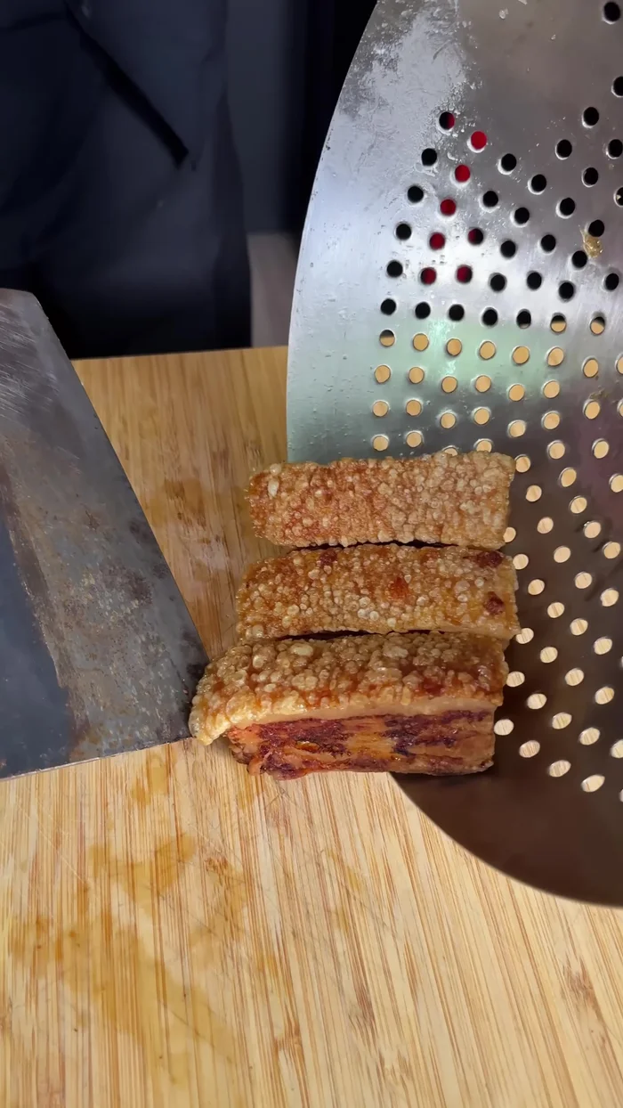 Chop up the fried pork belly.