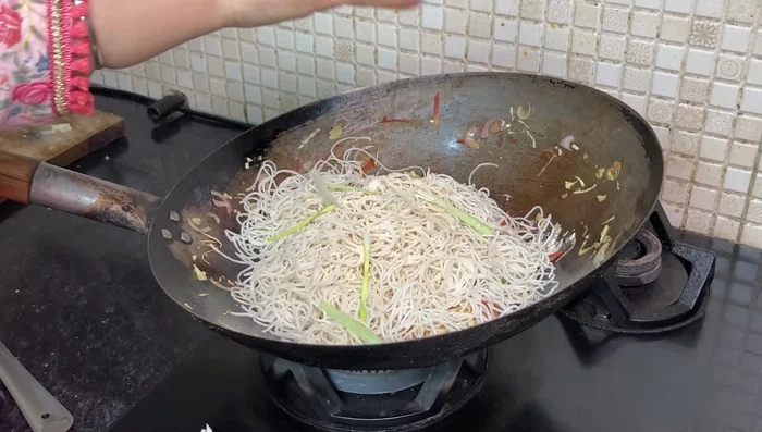 Add boiled noodles and toss gently with salt, fresh mate powder, soy sauce, and vinegar. Mix well to combine.