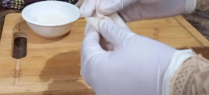 Create a small depression on the side with the filling, then bring the two corners together and overlap them. A little celery helps them stick.