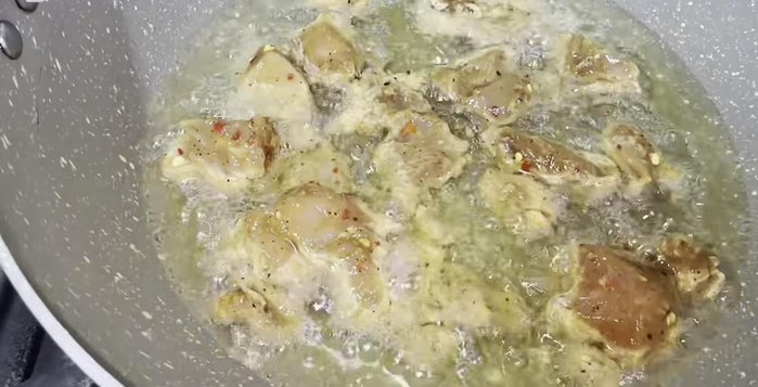 Fry chicken for Manchurian: In a pan with hot oil, fry the marinated chicken cubes until golden brown (3-4 minutes).