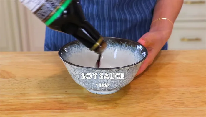 In a wok or large skillet, combine soy sauce, dark soy sauce, oyster sauce, and water. Whisk in cornstarch slurry (1 tbsp cornstarch + 3 tbsp water).
