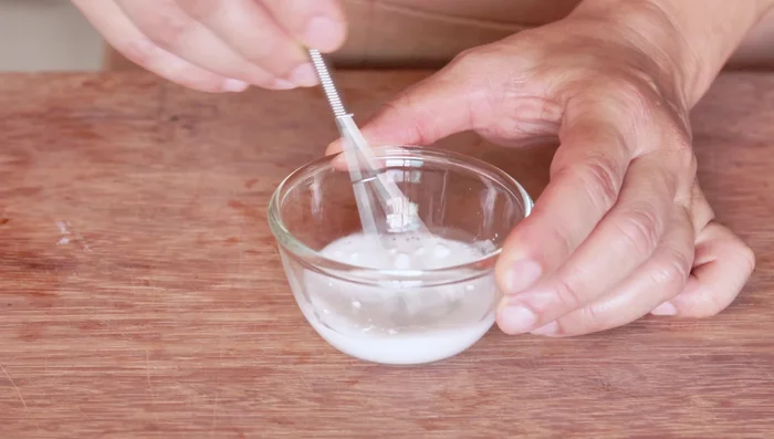Make a cornstarch slurry by combining cornflour with water until dissolved.