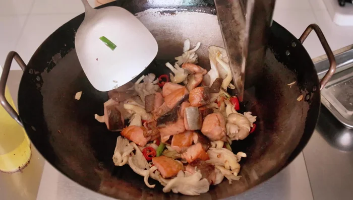 Add the salmon and sauce. Bring to a boil, then simmer until sauce reduces by half.