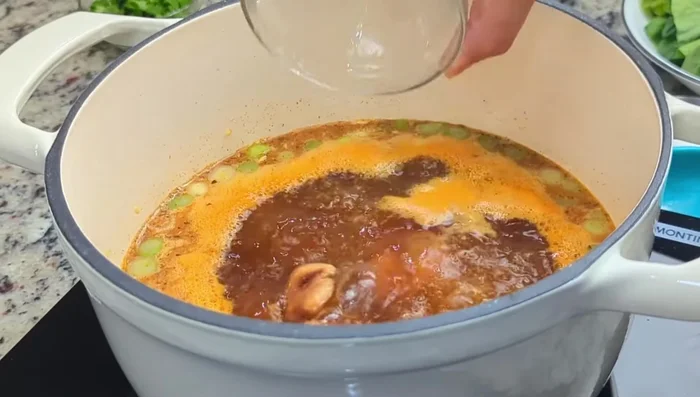 Add shitaki mushrooms (or substitute) and gai lan stems. Boil for about 5 minutes.