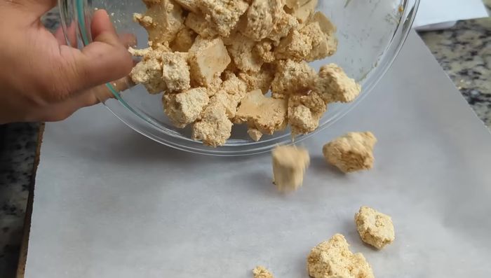 Transfer tofu to a parchment-lined air fryer tray, spread evenly. Optionally spray with cooking oil.
