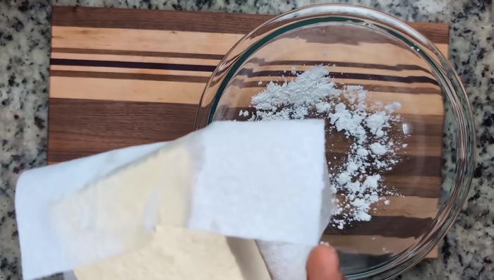 In a bowl, mix pressed tofu with cornstarch. Pat dry to remove moisture. Break tofu into bite-sized pieces.