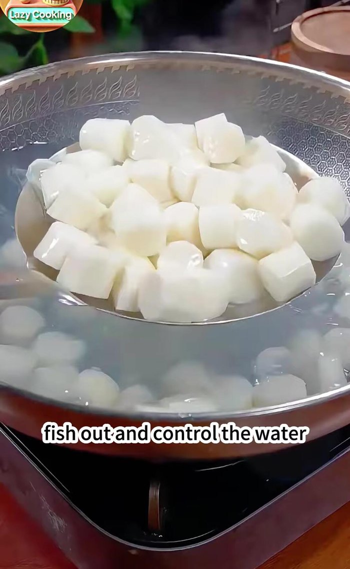 Fish out the yam and drain the water. Add two tablespoons of corn starch and toss with your hands to coat the yam evenly.