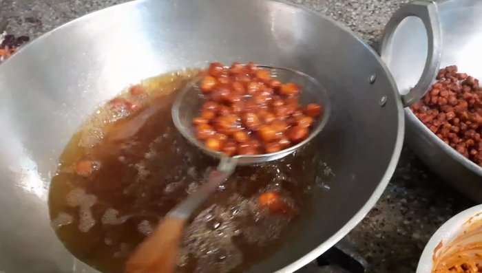 Add ginger, garlic, red chili, turmeric, and garam masala to the soaked soybeans. Mix well.