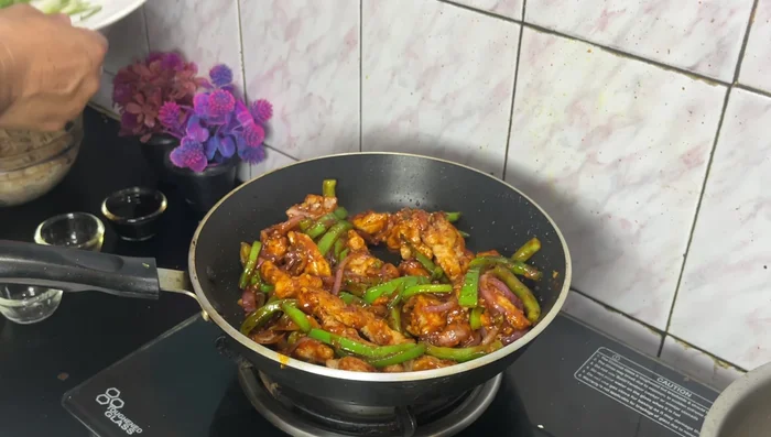 Fry the chicken again until crispy. Toss the fried chicken in the sauce and stir to coat.