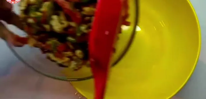 Transfer the cooked chicken and vegetable mixture to a bowl. Add 1 packet of mayonnaise and mix thoroughly.