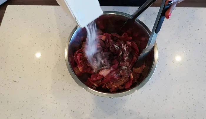 Add baking soda to the beef, ensuring it's fully covered. Let it sit for 30 minutes.