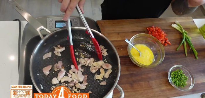 Pour the scrambled eggs into the pan with the chicken. The wet egg will help the rice not stick.