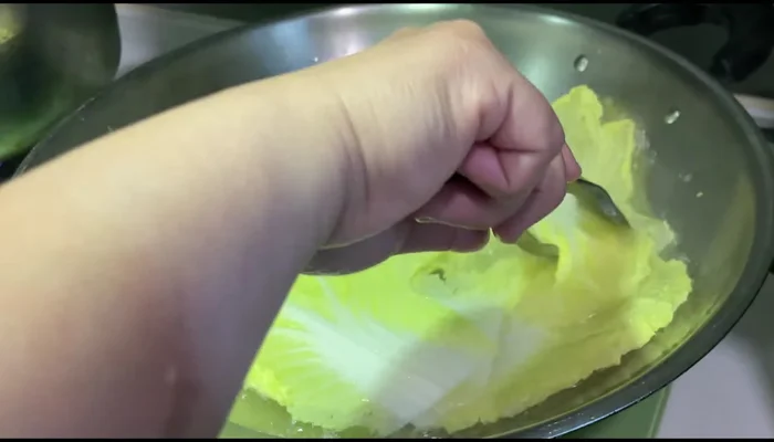 Assemble the cabbage rolls: Place a spoonful of the pork mixture onto each cabbage leaf and wrap tightly.