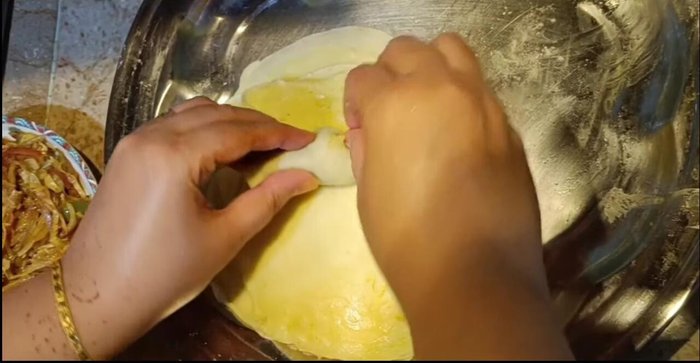 Once the stuffing has cooled, spread a little batter on a cooked patty, add the stuffing, and roll it up. Freeze for a short time to set.