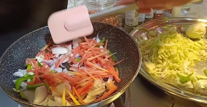 Sauté onions and carrots in oil, then add the remaining chopped vegetables and boiled eggs.