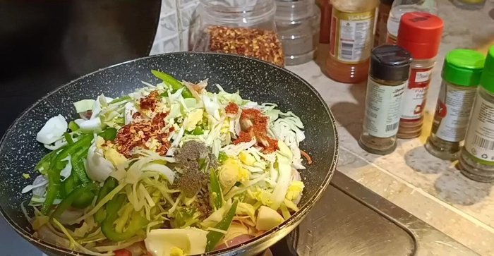 Add red chili powder, black pepper, chili flakes, garlic powder, paprika, parsley, basil, thyme, garam masala, vinegar, white vinegar, soy sauce, chili sauce, and salt to the vegetable mixture. Sauté until the water evaporates and the sauce is absorbed.