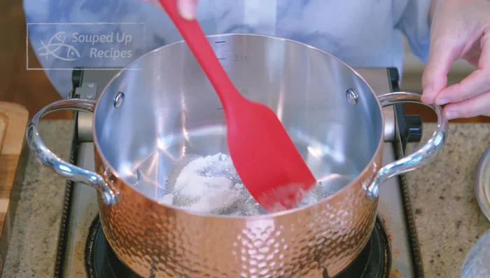 Caramelize sugar in a new pot with oil over medium-low heat. Add 4 cups of water carefully (hot caramel will splash). Bring to a boil.