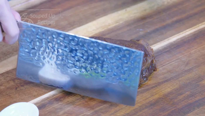 Chop the cooked beef. Add braising liquid in batches as you chop, until the meat is fully absorbed.