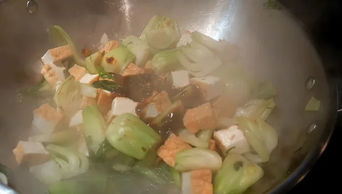 Add a small amount of oyster sauce and hot chili with fermented black soy bean. Stir well to combine flavors.