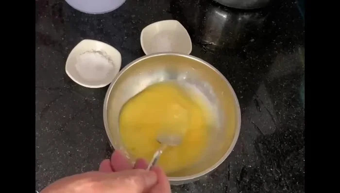 Beat the egg with half the water, salt, and sugar.