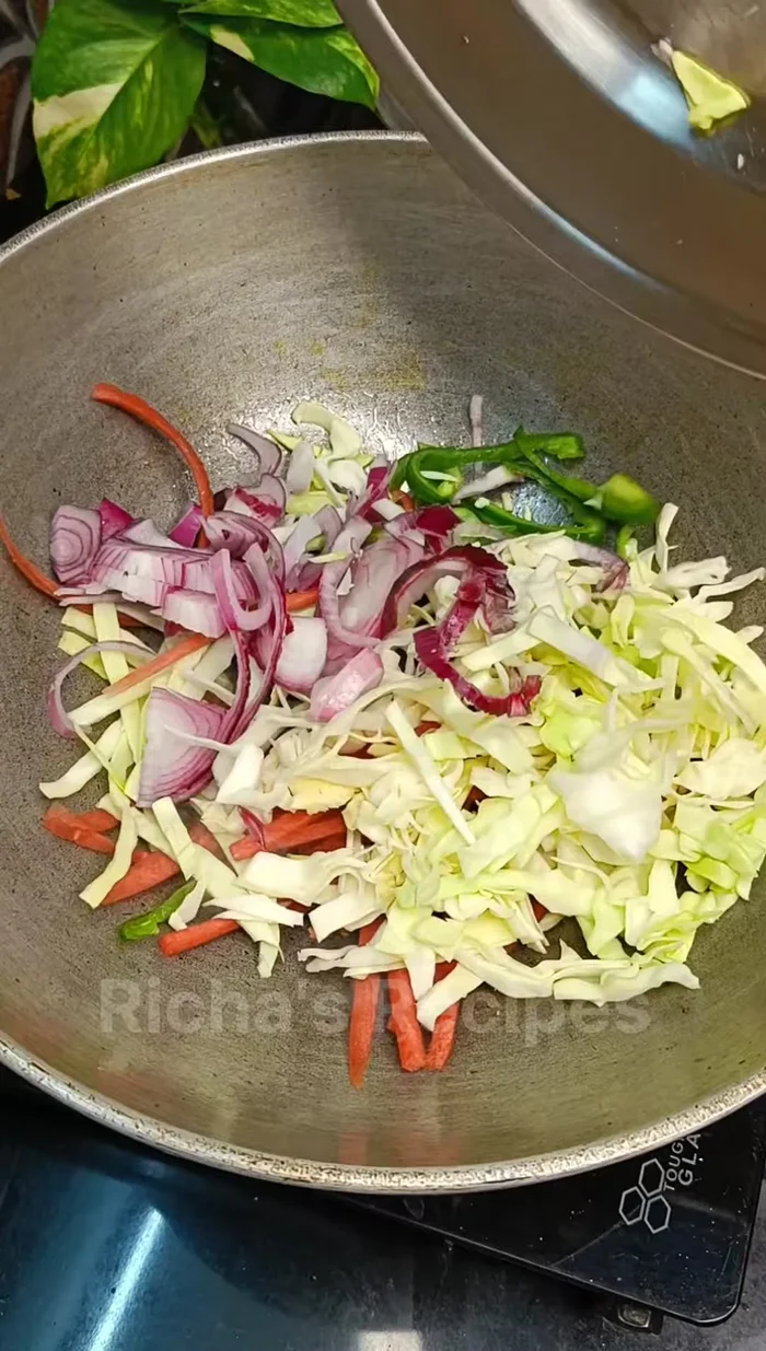 Add chopped onion, capsicum, carrot, and cabbage (or your preferred vegetables). Stir-fry on high heat for 1-2 minutes.