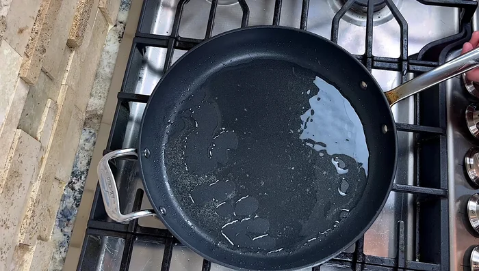 Stir-fry noodles: Add oil to the pan (medium heat). Add chopped green onion stems, sizzle until slightly golden brown. Increase heat to medium-high. Add noodles, toss to mix with oil and green onions.