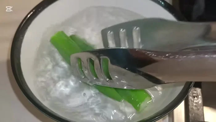 Remove lady fingers and immediately place them in a bowl of cold water.