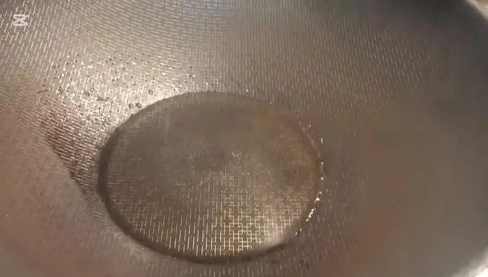 In a wok or pan, add 2 tablespoons of olive oil and heat until smoking.