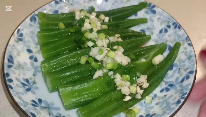 Pour the garlic and spring onion mixture over the blanched lady fingers.