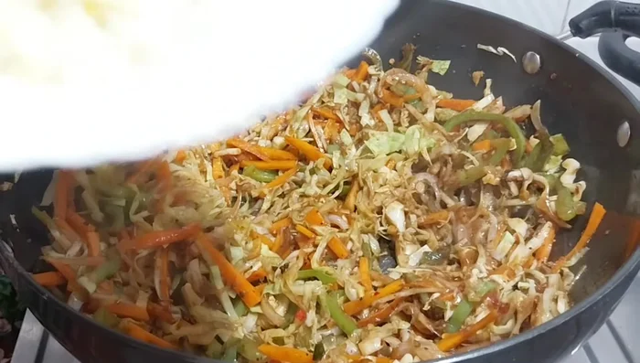 Turn off the heat. Add the grated eggs and chopped green coriander (and green onion if using). Gently mix.