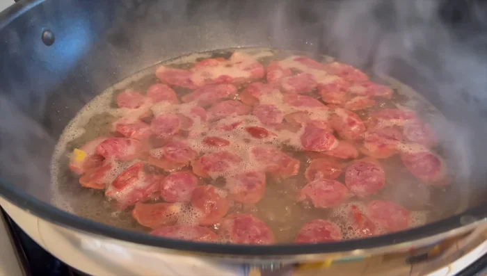 Heat water and steam Chinese sausage briefly to enhance flavor. Drain afterwards.