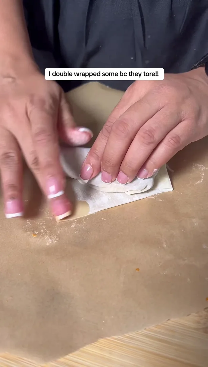 Pull the sides in, wrap tightly, and roll all the way up. Use a little water to seal the end.